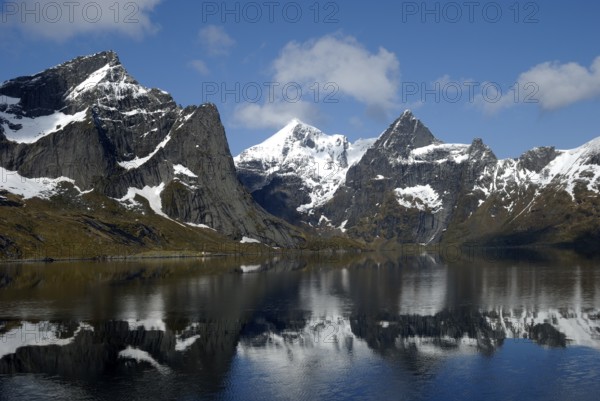 Mountains reflected in the water, Reinefjorden, Moskenesöya, Lofoten, Norway, Europe