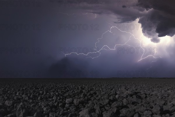Thunderstorm with lightning in plowed field. Thunderstorm background