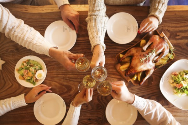 Christmas dinner with roast duck and champagne on wooden table. Top view