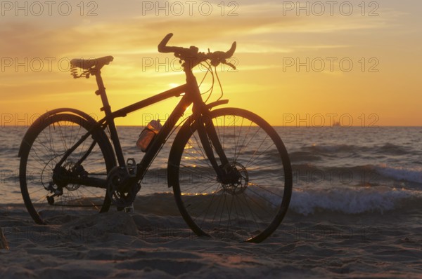 The silhouette of a Bicycle on the beach, Bicycle at sunset