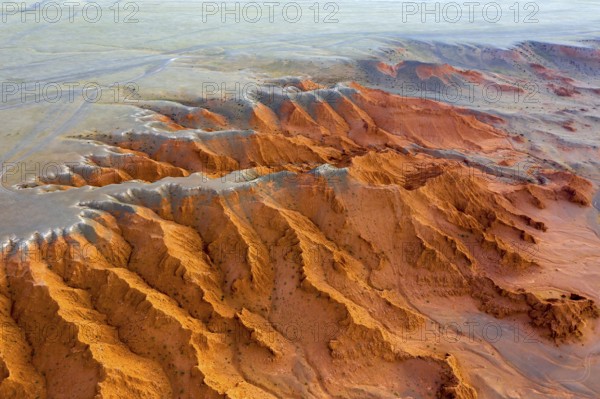 Aerial view of the Bayanzag flaming cliffs at sunset in Mongolia, found in the Gobi Desert