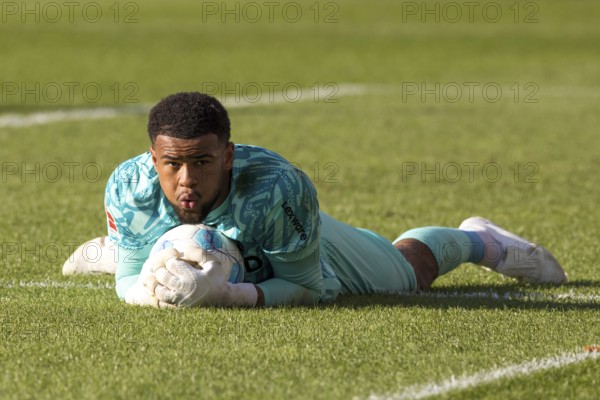 Football match, Noah ATUBOLU SC Freiburg safely holds the ball lying on the ground, Voith-Arena football stadium, Heidenheim