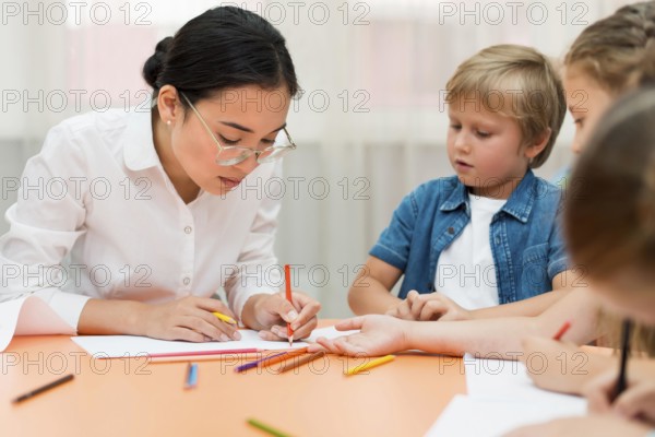 Young teacher doing her class with kids