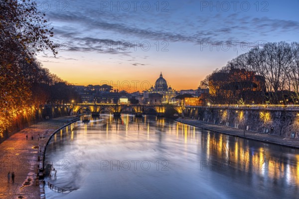 Dramatic sunset over the Basilica of St. Peter and the Tiber in Rome
