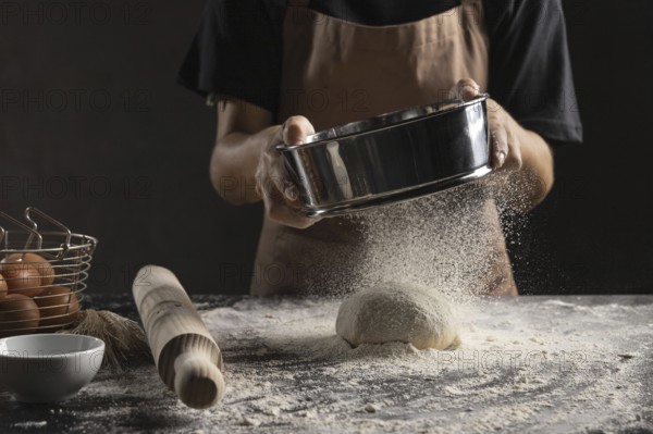chef dusting flour dough