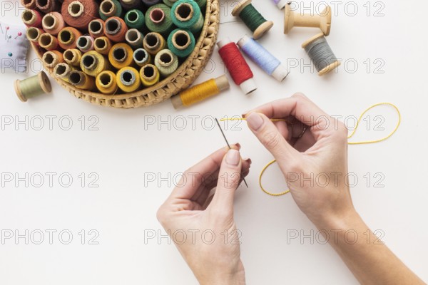 hands working with needle sewing thread. High resolution photo