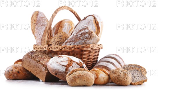 Composition with assorted bakery products in wicker basket isolated on white