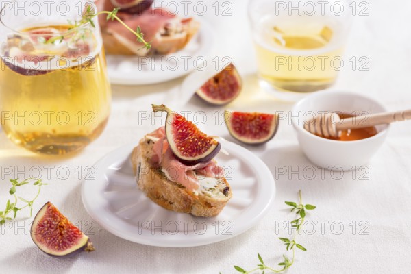 Small canape snack, crostini with ham, fig and apple wine, Italian antipasti