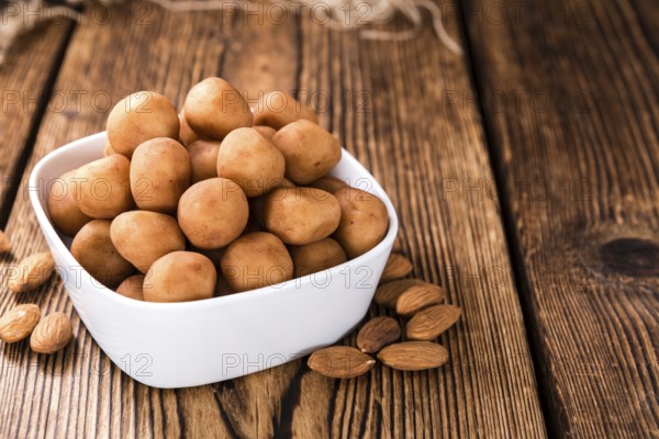 Homemade Marzipan Potatoes (German cuisine) on rustic wooden background