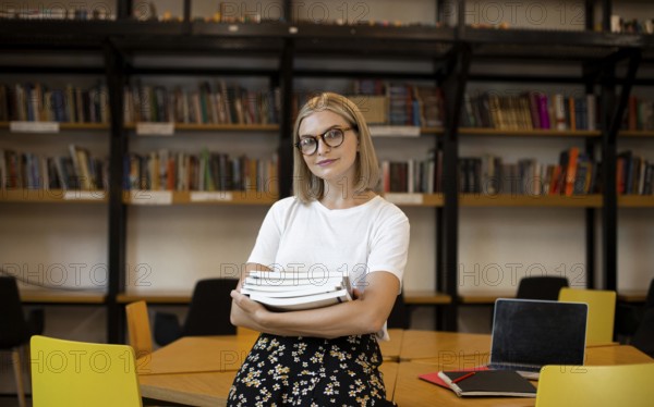 Pretty young woman posing library