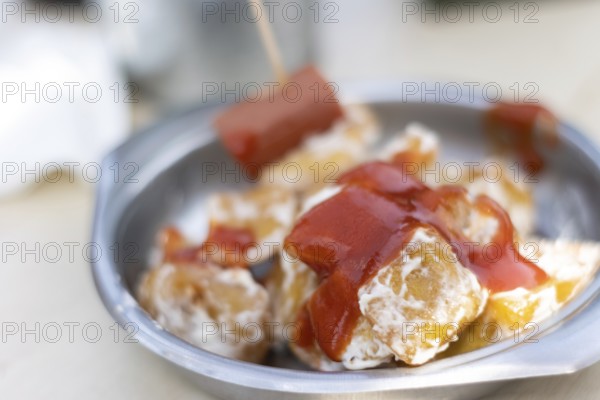 Close up of Spanish potatoes patatas bravas for tapas with tomato, mayonnaise and spicy sauce