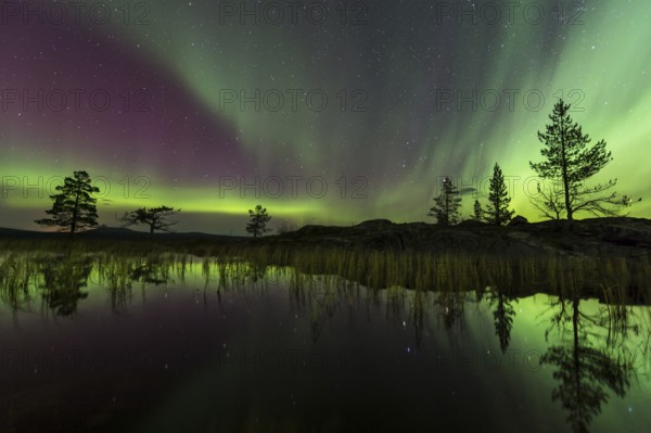 Northern Lights (Aurora borealis) reflected in a mountain lake, Gällivare, Norrbotten, Lapland, Sweden, October 2013, Europe