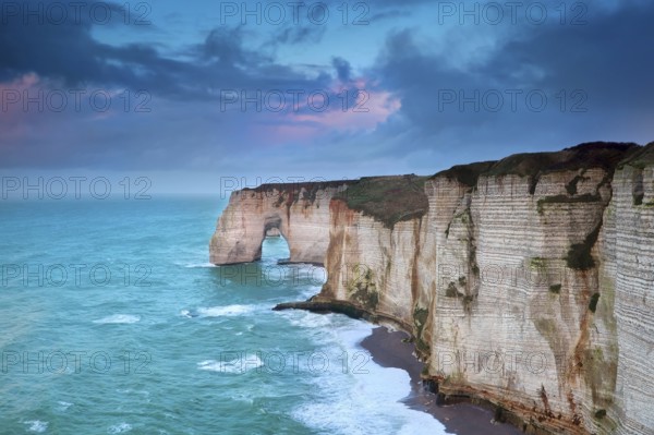 Rocky cliff in azure ocean waves, Etretat, Normandie, France, Europe