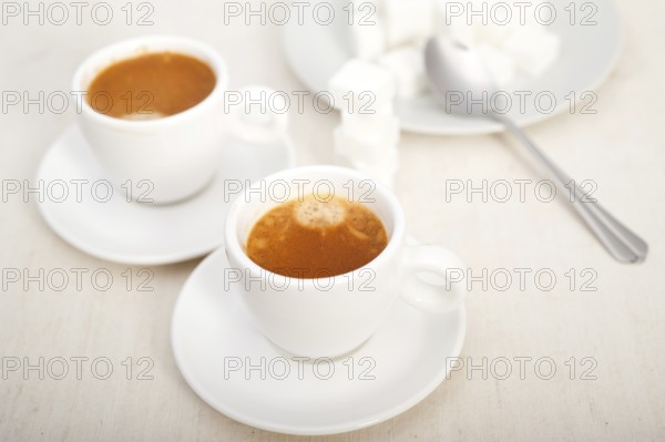 Italian espresso coffee fresh brewed macro closeup with sugar cubes