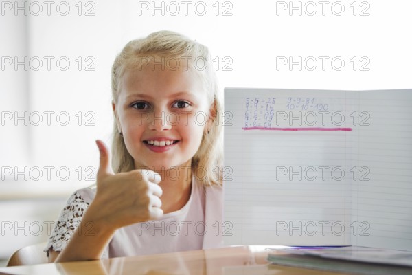 Girl sitting school table with notebook