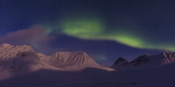 Northern Lights (Aurora borealis) over moonlit mountains in the valley Stuor Reaiddavaggi, Kebnekaisefjaell, Norrbotten, Lapland, Sweden, March 2013, Europe