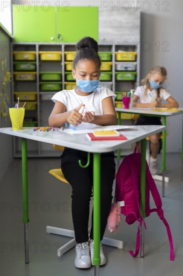 Little girl disinfecting class