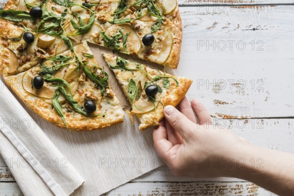 Top view hand taking slice pizza