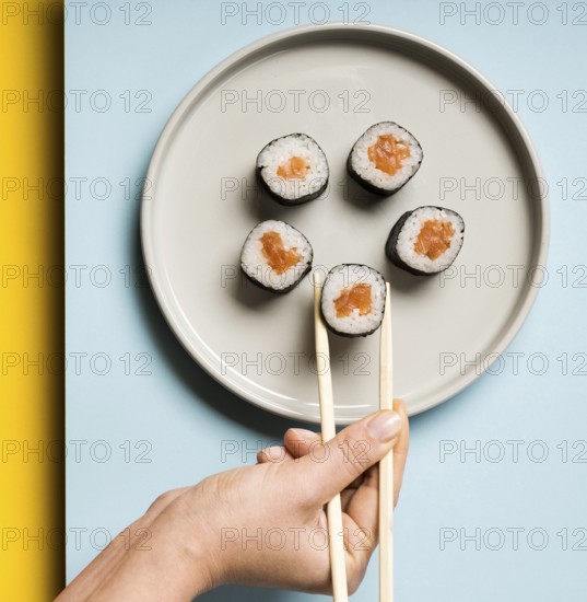 Minimalist plate with sushi rolls chopsticks