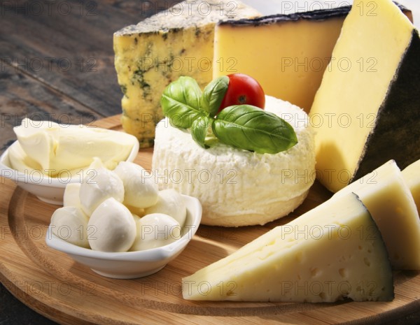 Different sorts of cheese on kitchen table