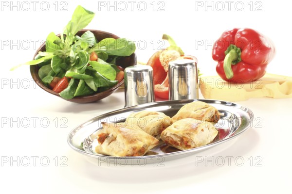 Puff pastry pockets with peppers and cheese against a light background