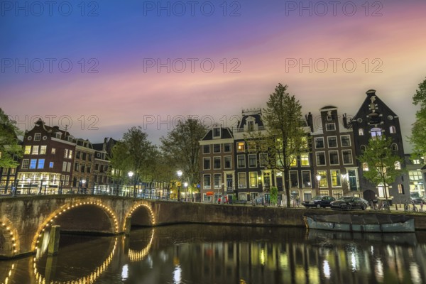 Amsterdam Netherlands, night city skyline of Dutch house at canal waterfront