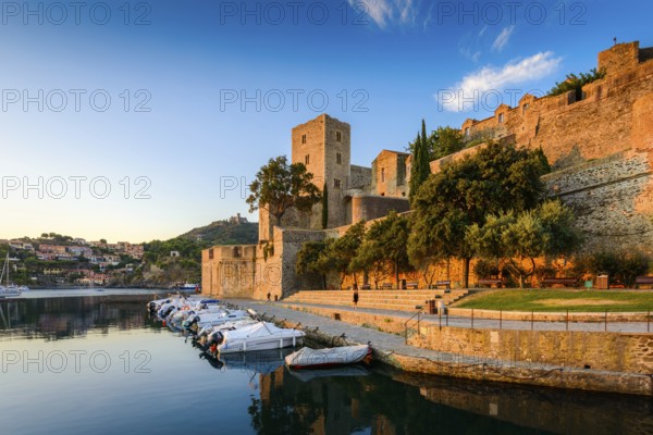 Medieval castle and boats at Collioure city at sunrise at Occitanie in France