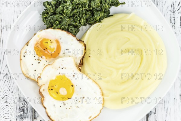 Portion of homemade Mashed Potatoes on wooden background (selective focus, close-up shot)