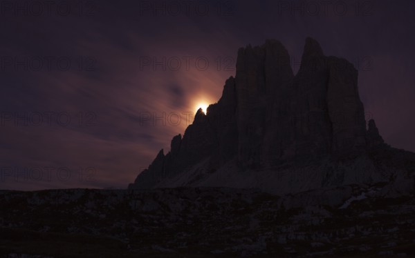 Setting full moon on the edge of the smaller Three Peaks, Hochpustertal valley, Sexten, South Tyrol province, Trentino-Alto Adige, Italy, Europe