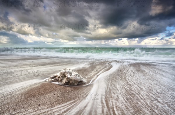Clouded sky and ocean waves with long exposure, Etretat, France, Europe