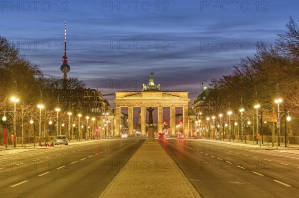 The famous Brandenburg Gate in Berlin with the TV tower at dusk