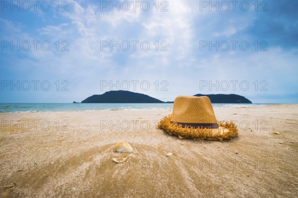 Hat and Shell on tropical beach
