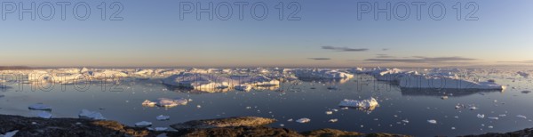 Ilulissat, Greenland, July 7, 2018: Panoramic view of the Ilulissat Icefjord during midnight sun. Ilulissat Icefjord was declared a UNESCO World Heritage Site in 2004, North America