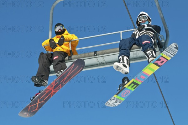 Snowboarders on a ski lift, Canada Olympic Park, COP, Calgary, Alberta, Canada, North America
