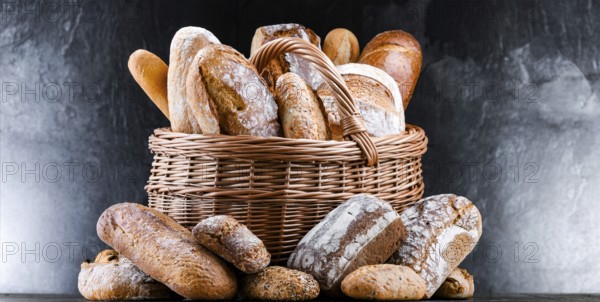 Wicker basket with assorted bakery products including loafs of bread and rolls