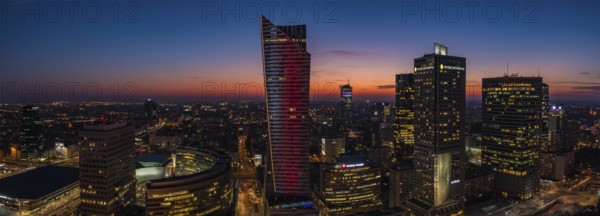 A panorama picture of the sun setting over Warsaw's business center and skyscrapers