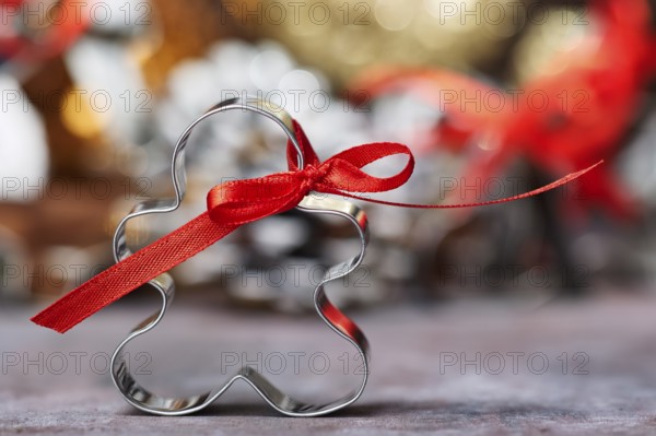 Cookie Cutter with Red Bow in Front of Christmas Decoration
