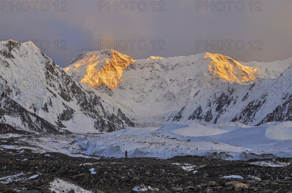 Inylcheck glacier in Kyrgyzstan with Pik Pobeda peak lit by early morning sun