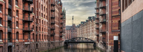 panoramic view of canal and historic buildings in old warehouse district Speicherstadt in Hamburg, Germany, Europe
