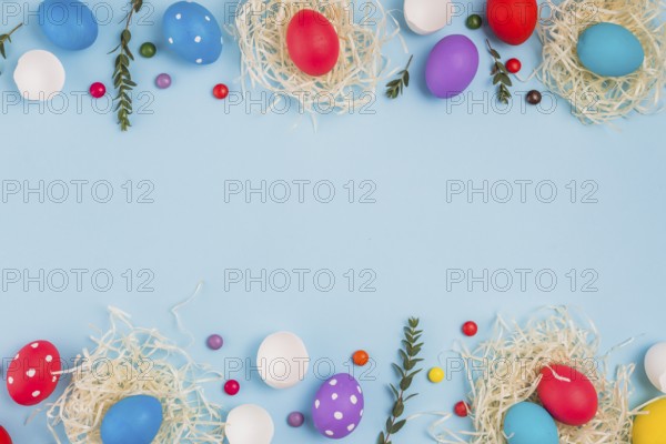 Easter eggs nests with plant branches candies