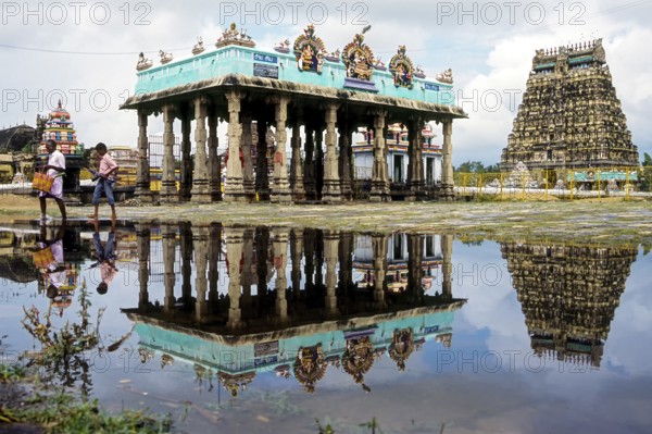 Thillai Natraja temple north tower and mandap along with its reflection in the rain water, Chidambaram, Tamil Nadu, South India, India, Asia