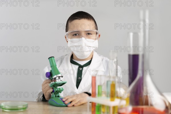 Boy laboratory with microscope