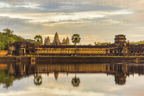 The ancient Khmer temple of Angkor Wat illuminated by the rays of the setting sun