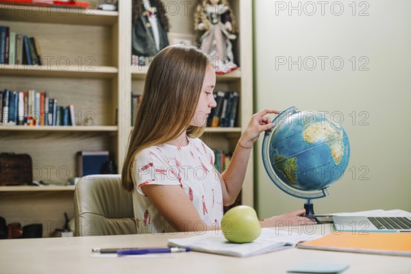 Student posing with globe table