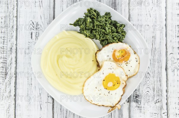 Potato Mash on rustic wooden background (close-up shot)