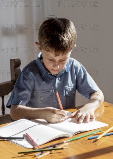 Medium shot kid writing notebook