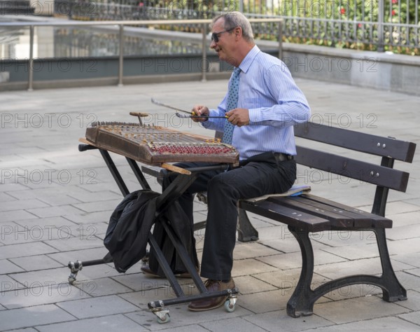 BUCHAREST/ROMANIA, SEPTEMBER 21 : Man playing an old musical instrument in Bucharest Romania on September 21, 2018. One unidentified man