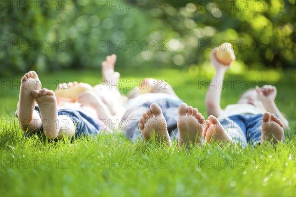 Family playing on green grass in spring park