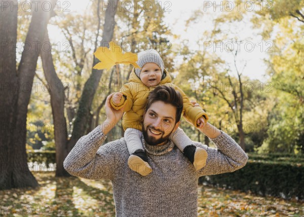 Smiley dad with his baby outside nature