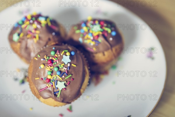 Homemade sweet cupcakes on a plate with colourful decoration